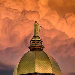 June 20, 2016; Storm clouds lit by the setting sun behind the Dome. (Photo by Matt Cashore/University of Notre Dame)