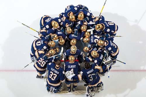 The Hockey team huddles before the opening puck drop.