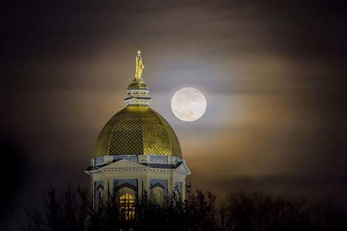 Moonrise behind the Golden Dome.