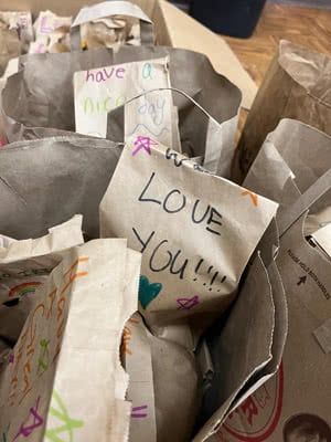 Paper bags with kind notes written on them.