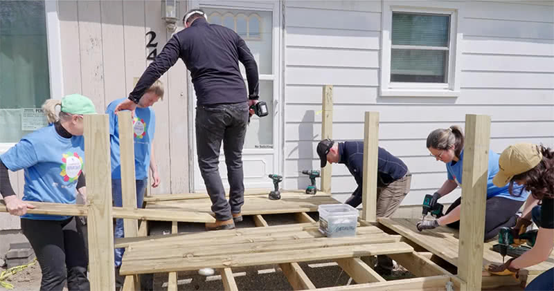 Workers helping install a deck on Notre Dame's Global Day of Service