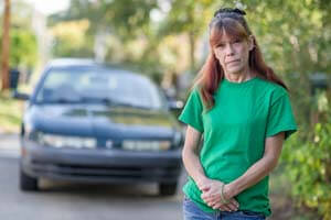 Lisa McDaniel in front of her car