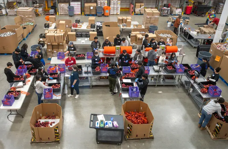 Volunteers package food at the Northern Illinois Food Bank