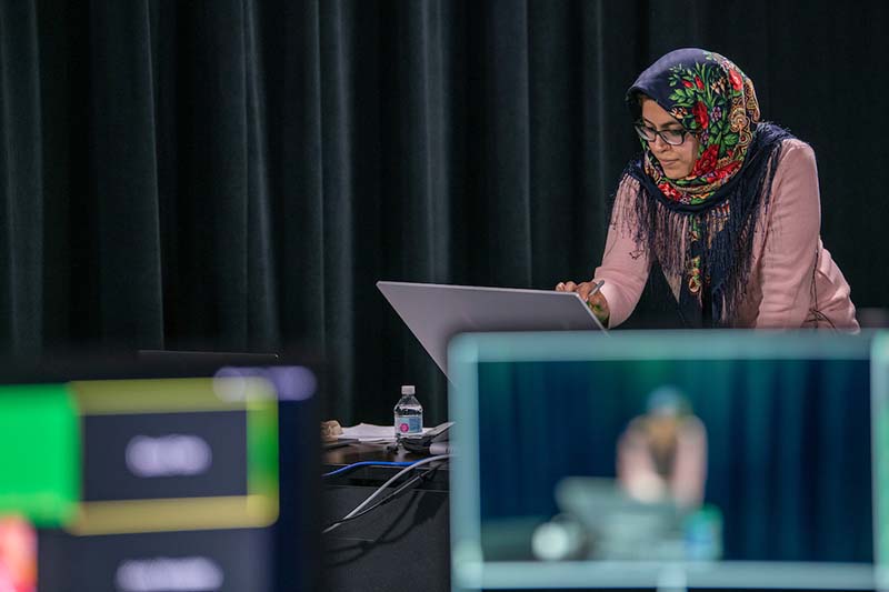 A woman works on a computer, with screen recording in foreground.