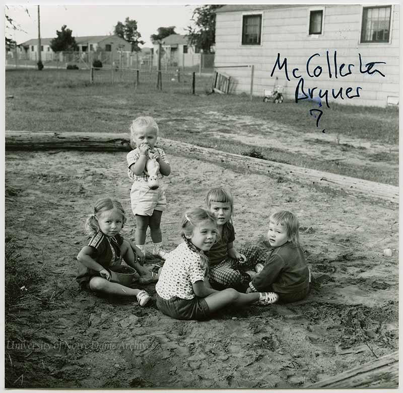 A group of girls playing in a sandbox, c1950s.