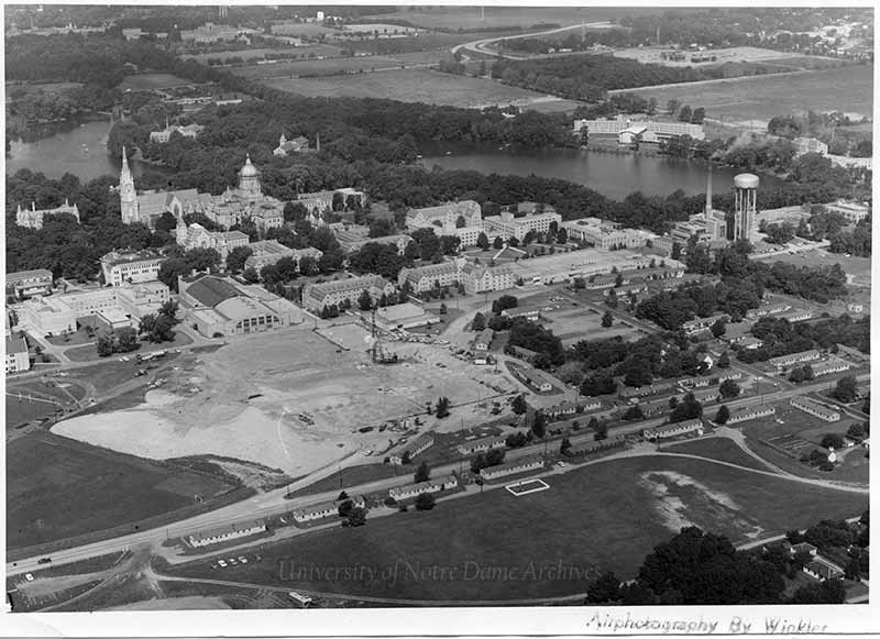 Campus aerial view of workers clearing land.