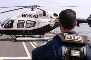 A NYPD officer walks to a helicopter.