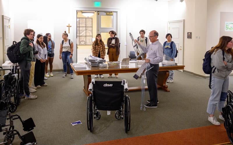 John Mellor gives teams of students a wheelchair, crutches and a blindfold.