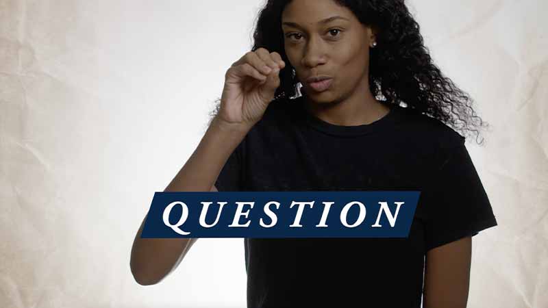A Black woman wearing a black t-shirt uses sign language, 'Question' text on top of the image.