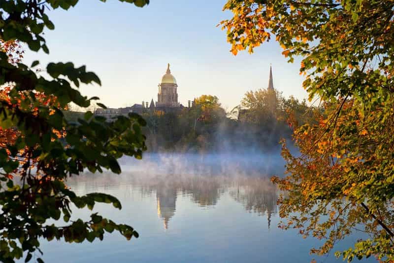 Fall leaves frame Notre Dame's main building and the Basilica of the Sacred Heart.
