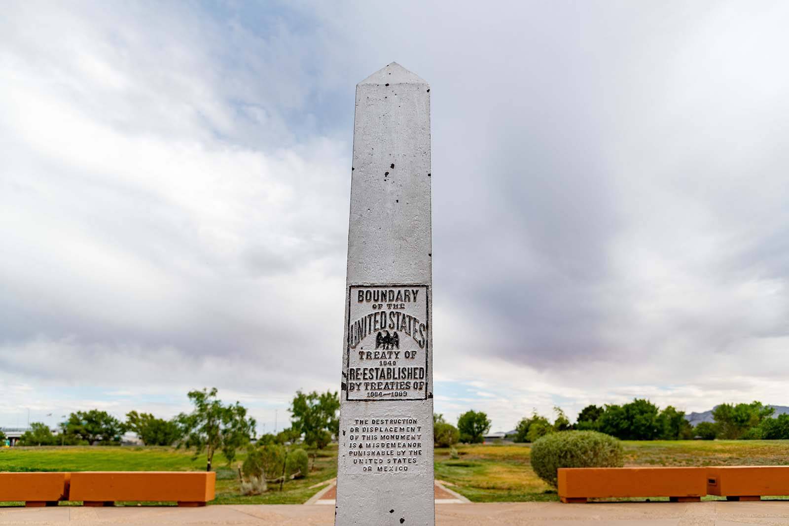 An obelisk reads 'Boundary of the United States. Treaty of 1849. Re-established by treaties of 1864-1889.'