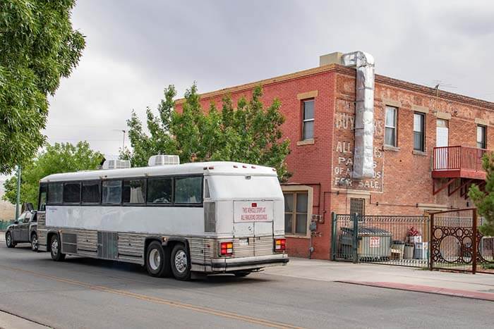 A bus pulls up to the two-story brick building that is Casa Vides.