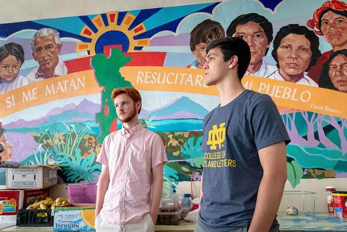 Francis Brockman, left, and Daniel Rottenborn stand in front of colorful mural in Casa Vides.