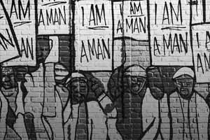 I am a Man Mural, Colorful painting on a brick wall depicting the African-American Memphis Sanitation Strike of 1968.