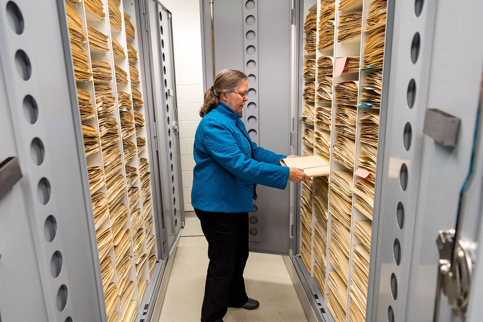 Barbara Hellenthall looks up samples in the herbarium in Jordan Hall of Science.