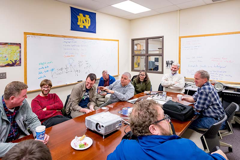A group of high school teachers sit around a table.