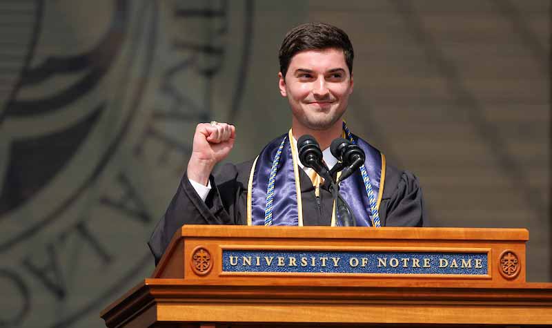 Brady Stiller speaks at a podium.