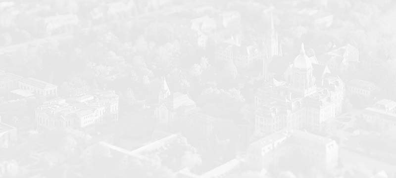 A faded and stylized gray background image of Notre Dame's campus