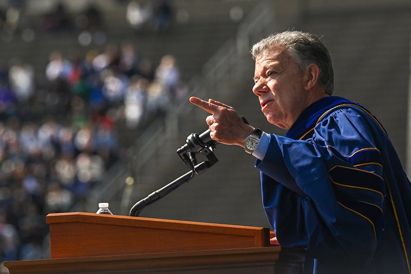 Juan Santos firmly speaking while pointing his finger.