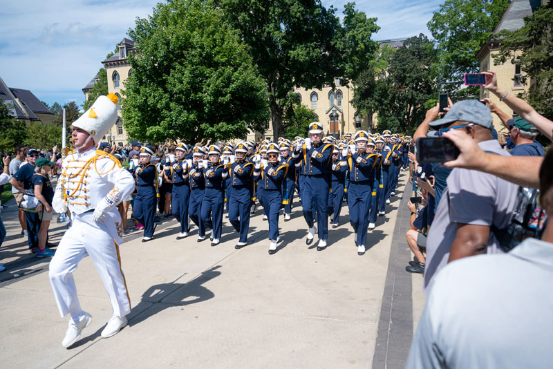 Drum major John Sexton leads the marching band through campus on game day