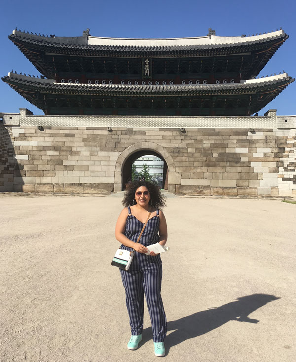 Karen Angeles stands in front of a building in Korea.