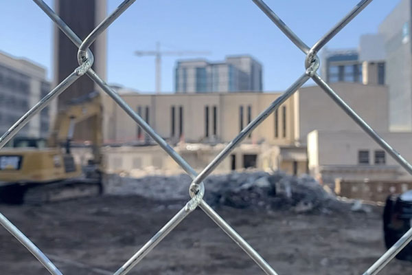 The St. Austin Parish construction site as viewed through a chain link fence.