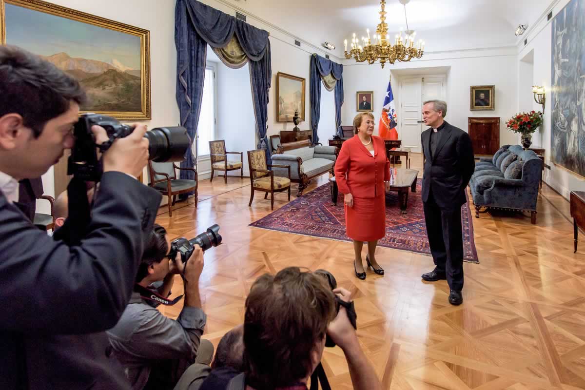 President Michelle Bachelet of Chile greets University of Notre Dame President Rev. John I. Jenkins, C.S.C. at La Moneda Presidential Palace, in advance of an extended discussion between the two and Provost Thomas Burish, Vice President for Internationalization J. Nicholas Entrikin and Chilean Foreign Affairs Minister Heraldo Muñoz Valenzuela on international education and other issues.