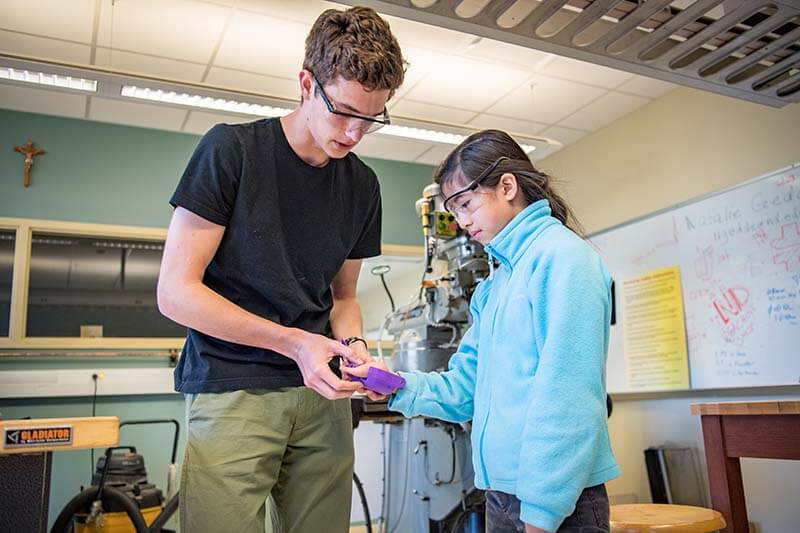 Cole Grabowski fits Tori Anderson with a 3D-printed prosthetic hand.