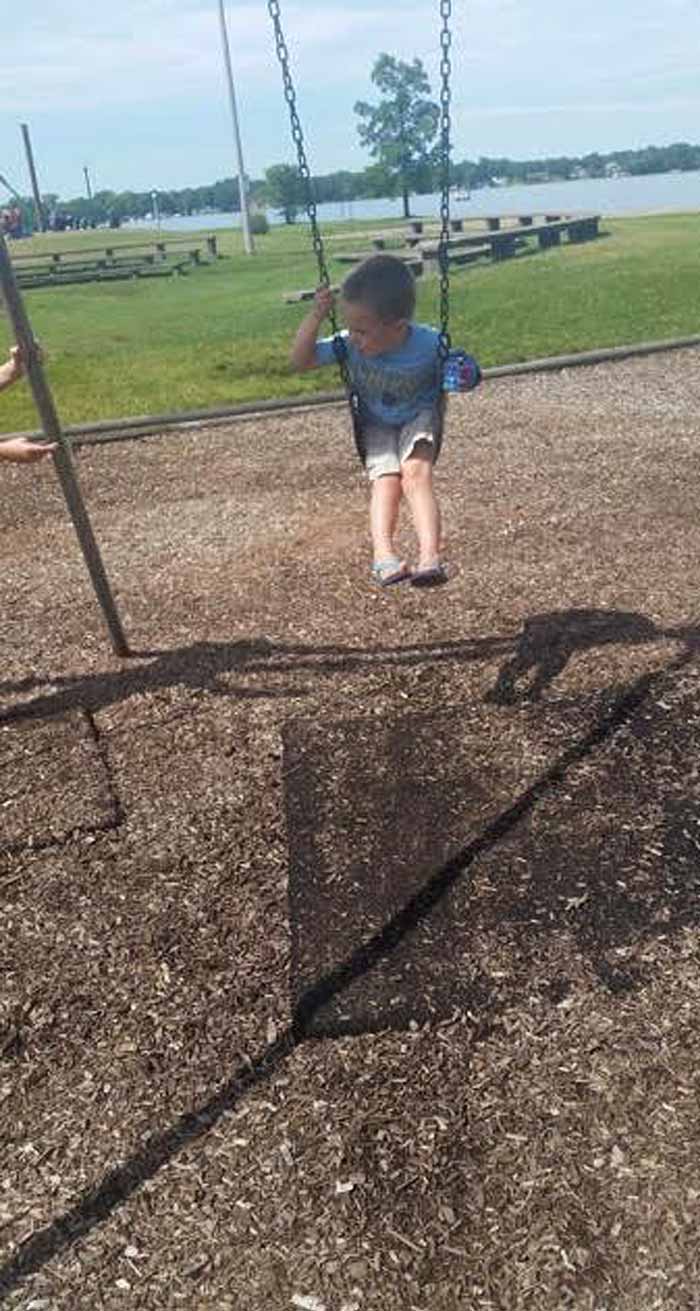 Owen Lewis using his prosthetic on a swing