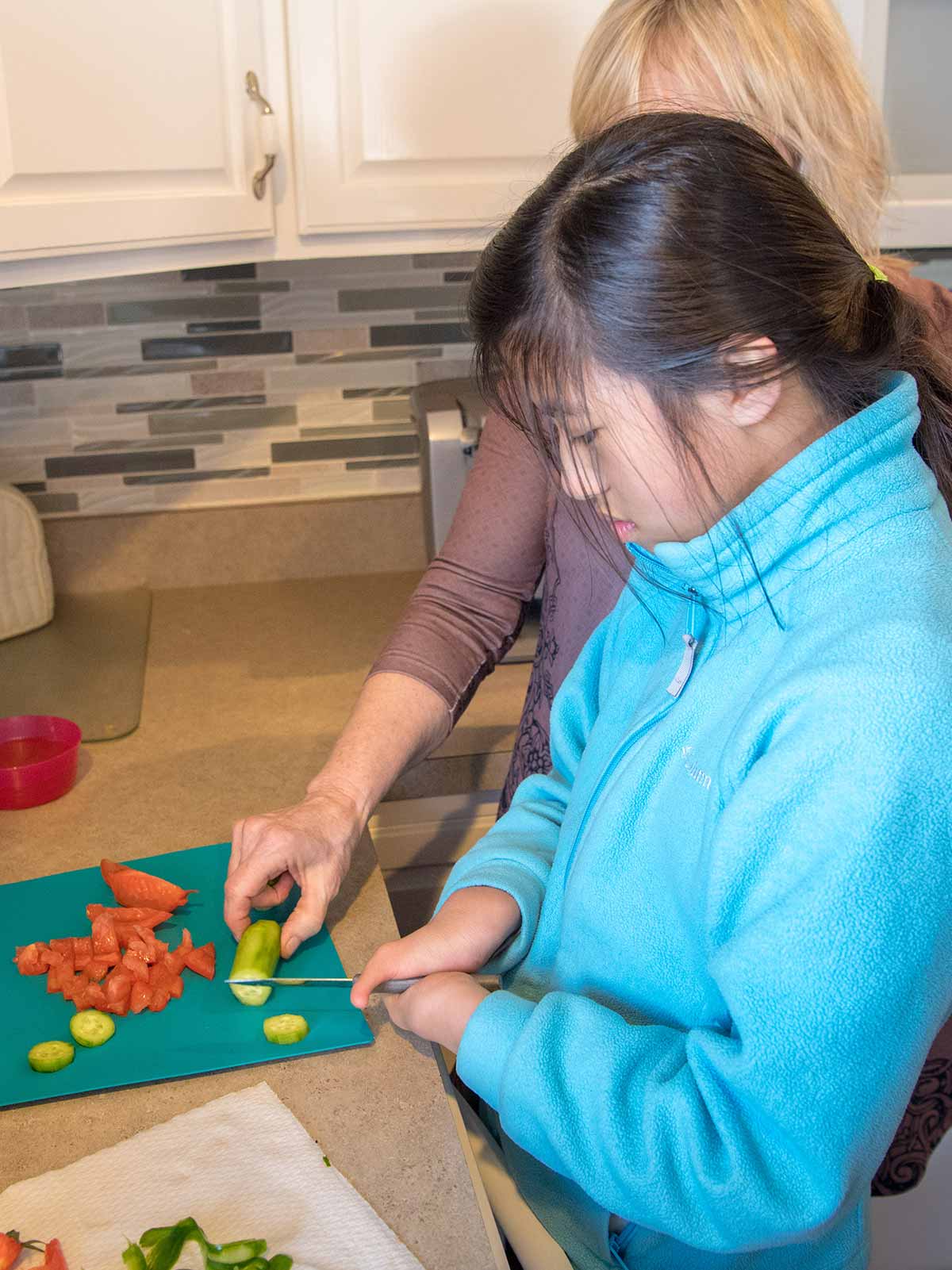 Tori prepares dinner with her mother, Mary Wehr-Anderson, in their South Bend home.