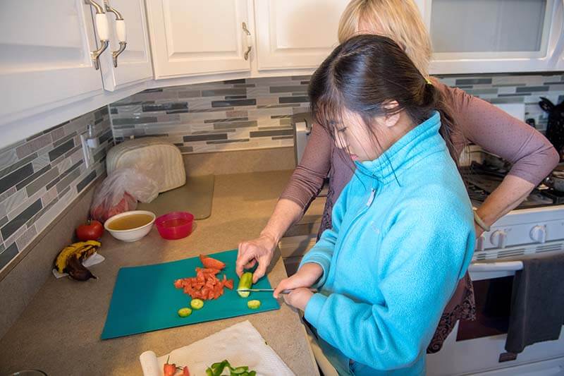 Tori prepares dinner with her mother, Mary Wehr-Anderson, in their South Bend home.