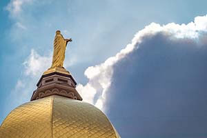 Gold dome of Main Building in front of a blue sky