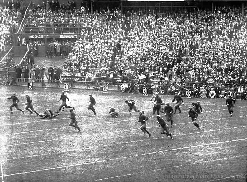 Football game scene, players running on the field.