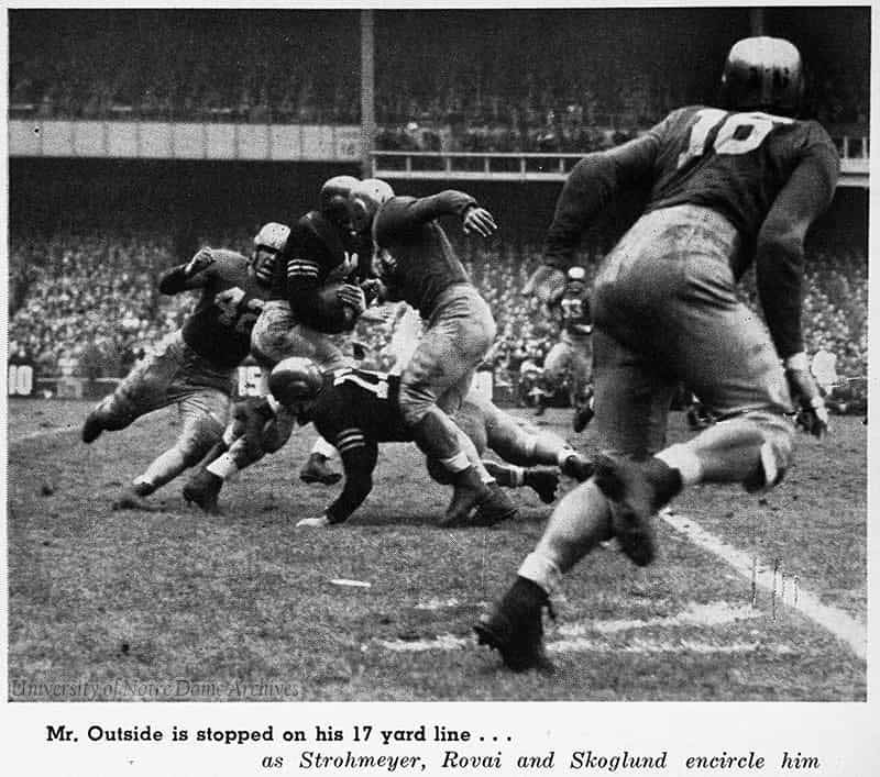 Football player running with the ball with caption 'Mr. Outside [Gerry Cowhig] is stopped on his 17 yard line ... as Strohmeyer, Rovai and Skoglund encircle him.'