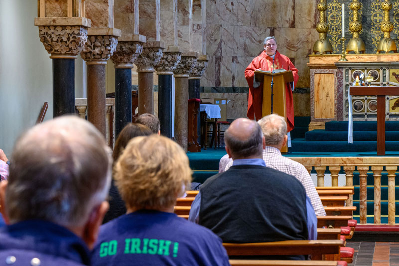 Rev. Gary Chamberland, C.S.C. celebrates daily Mass inside Newman University Church in Dublin.