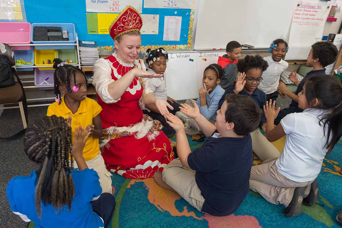 Oksana Glazkova, a Russian FLTA, plays a clapping game to help learn Russian words and phrases with a third-grade class at Perley Fine Arts Academy
