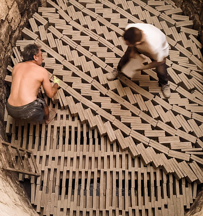 Bricks being placed in the kiln in preparation for firing.