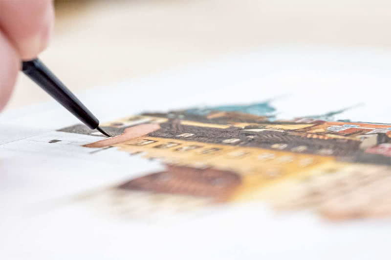 Close up narrow focus of an artistic marker coloring a section of an archeological drawing.