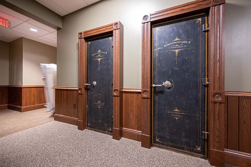 Two black safe doors with gold enscription.