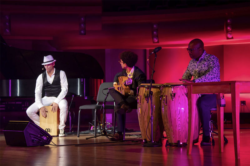Flamenco artist Jaime El Estampio sits on his beat box on the stage at DeBartolo Performing Arts Center.