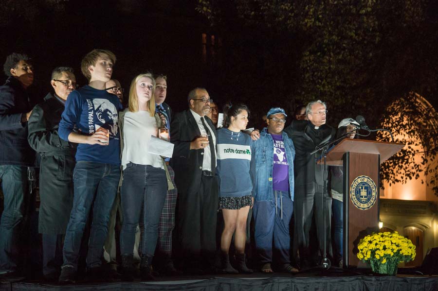 November 14, 2016; University President Rev. John I. Jenkins, C.S.C. sings the Alma Mater with students following an interfaith prayer service for respect and solidarity in front of O’Shaughnessy Hall.