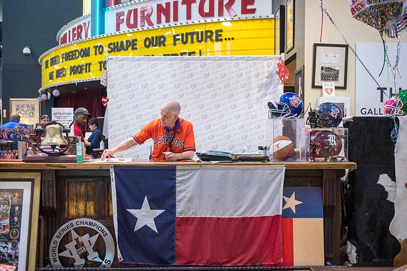 Gallery Furniture owner Jim McIngvale, also known as Mattress Mack, works at the front counter of his flagship store in Houston, Texas.