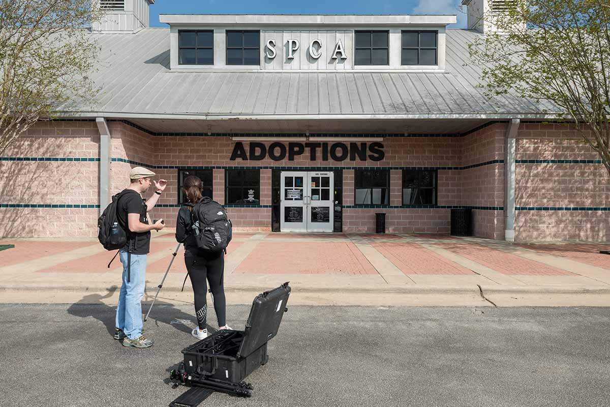 Eric Nisly helps Kelli Smith as she records video outside Houston SPCA in Houston, Texas.