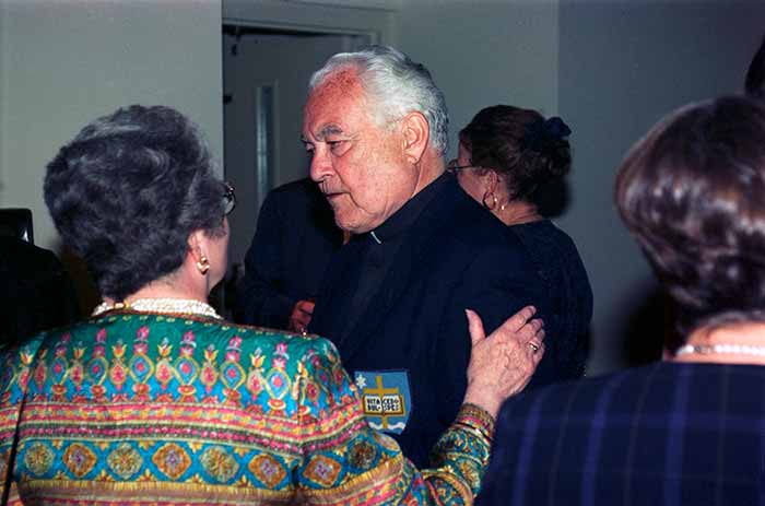 Isabel Charles talking with Rev. Theodore M. Hesburgh at her Retirement Party, 1995.