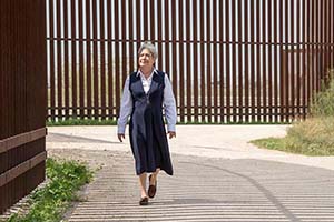 Sister Norma Pimental walks along the border wall.