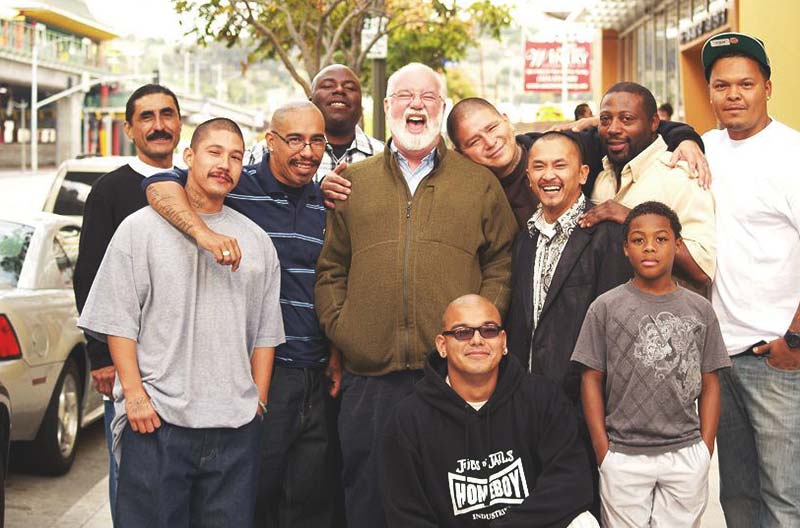 Greogry Boyle with a group of men on a city street