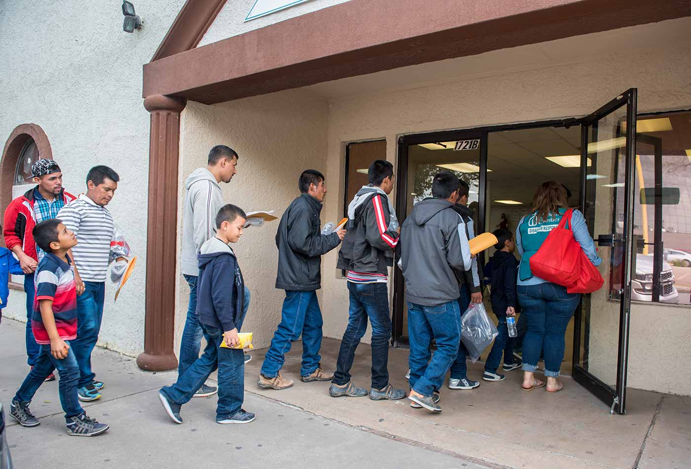 Refugees entering the Catholic Charities building.