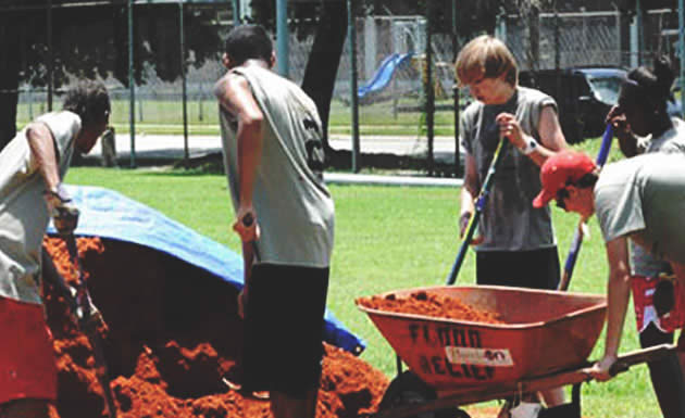 Five students moving dirt