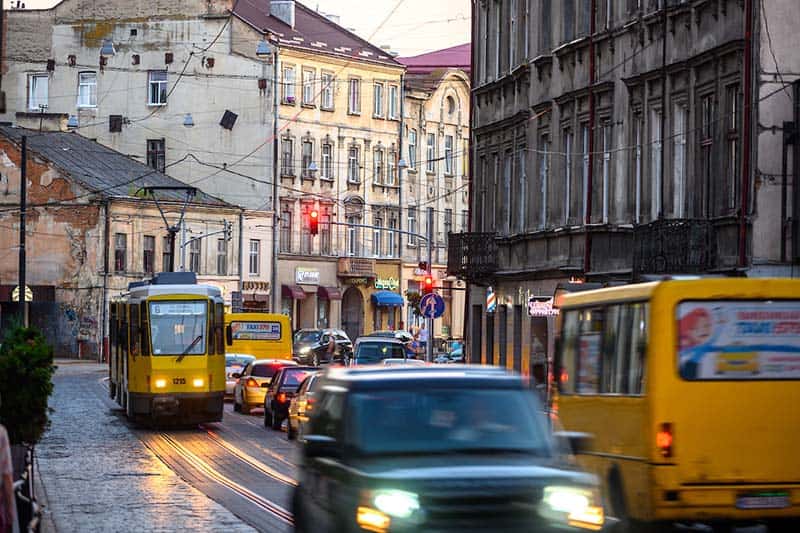 Cars and cable cars drive on a busy street in Lviv, Ukraine.