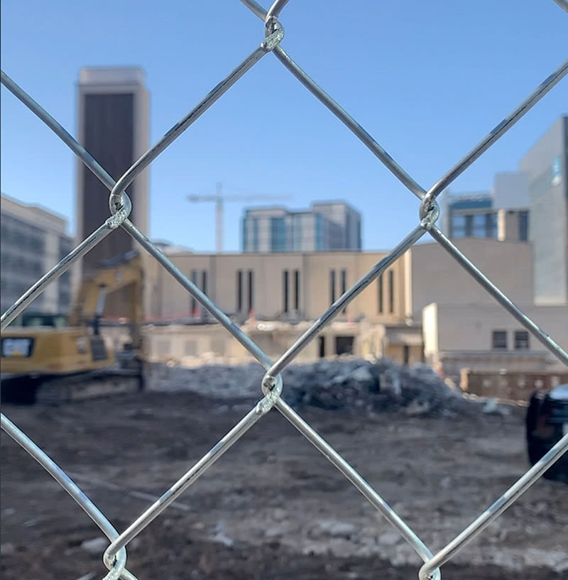 The St. Austin Parish construction site as viewed through a chain link fence.